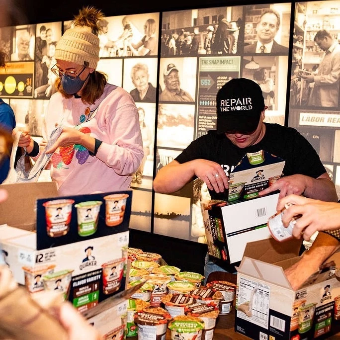 A Repair the World Los Angeles Senior Program Associate and and additional volunteers package food donations for those in need.