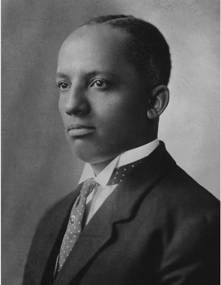 A black and white portrait of Dr. Carter G. Woodson.