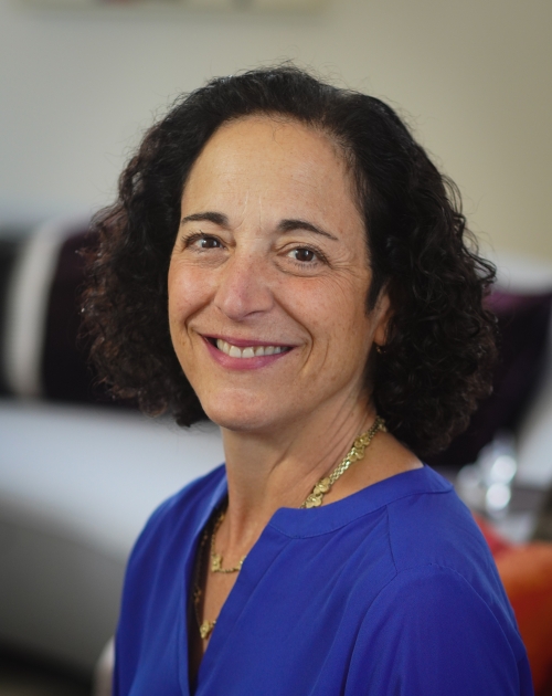 Image of Stacy Schusterman Chair of Charles and Lynn Schusterman Family Philanthropies smiling at the camera wearing a blue top.